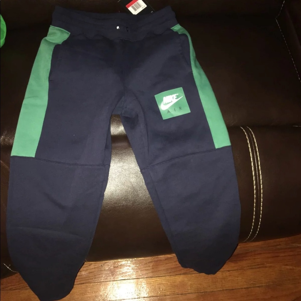 Navy blue and green Nike joggers